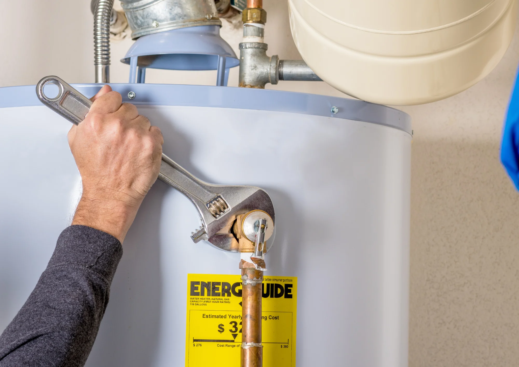 Rockwall Plumbing technician performing a maintenance check before flushing a residential water heater to prevent sediment buildup