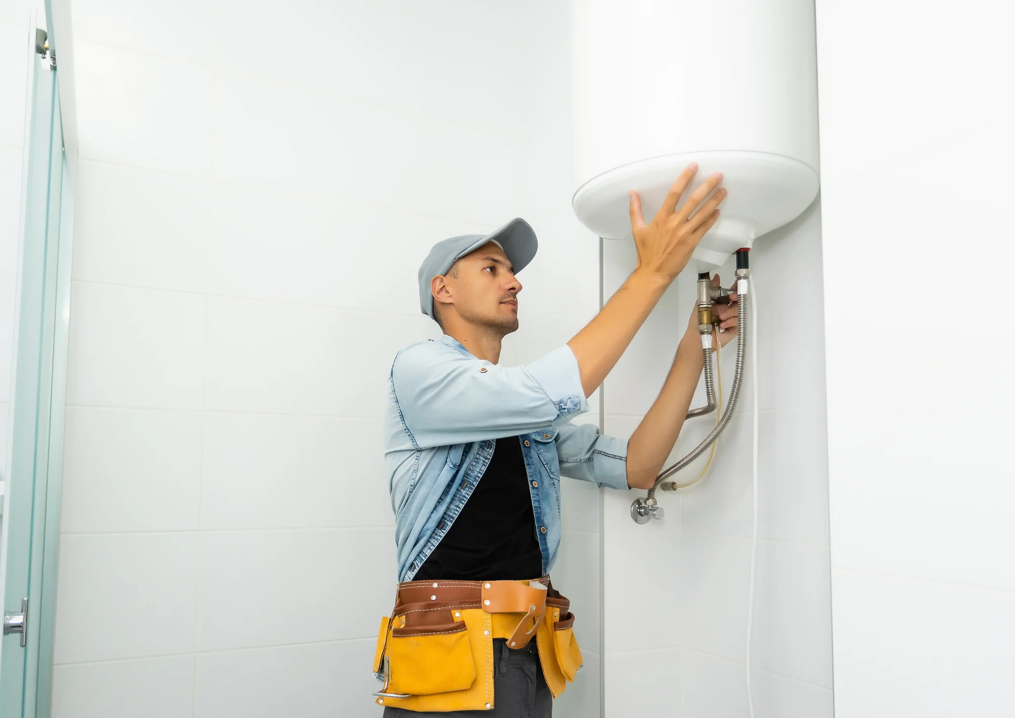 Plumber repairing and flushing a hot water heater to extend its lifespan in Rockwall, TX